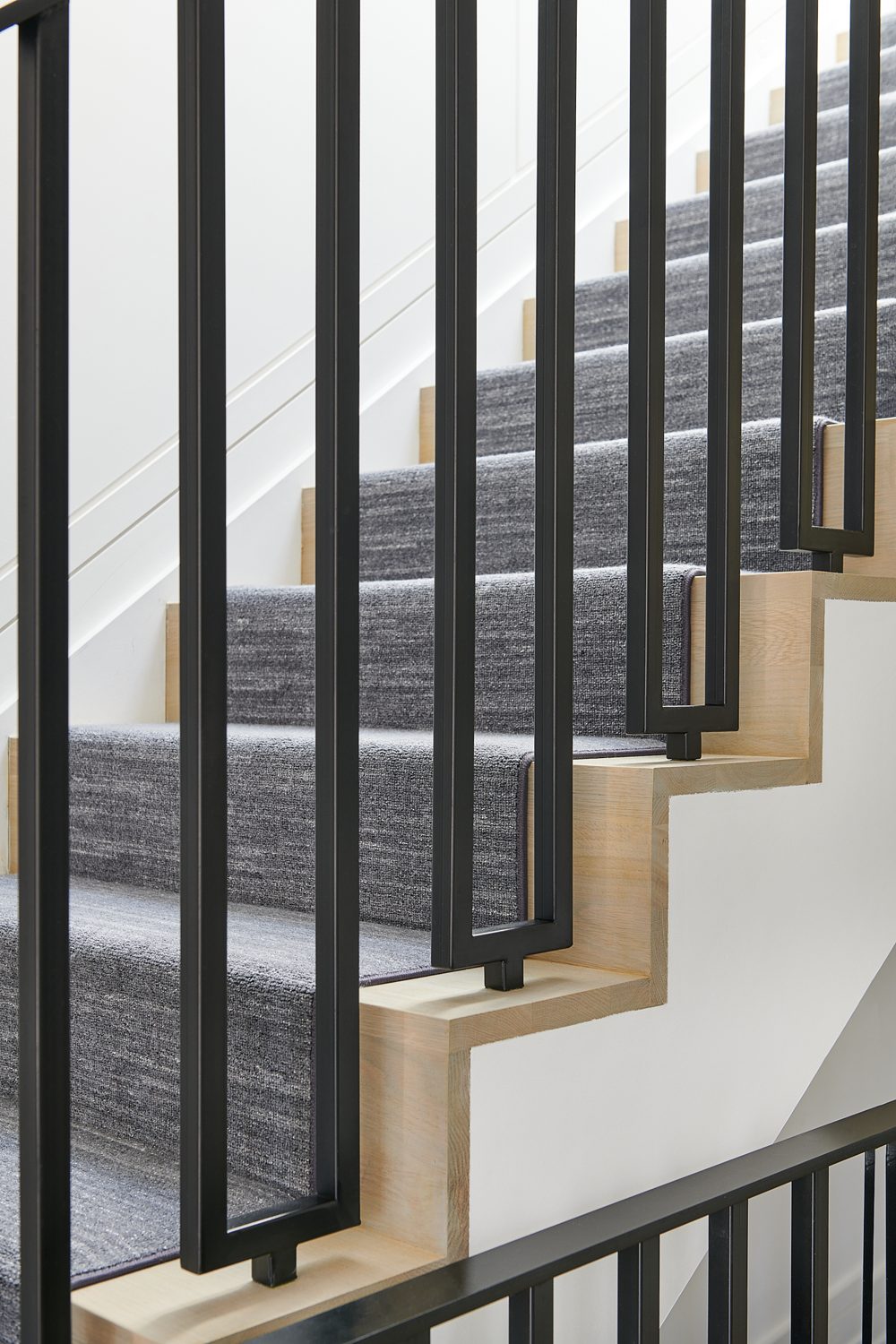 A stair rail, runner and oak treads, up close